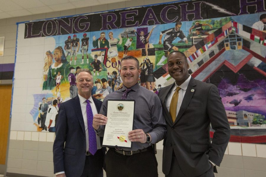 Principal Wasilewski (center) being presented with the award by Superintendent Martirano (left) and County Executive Calvin Ball (right). Photo courtesy of Long Reach High School.