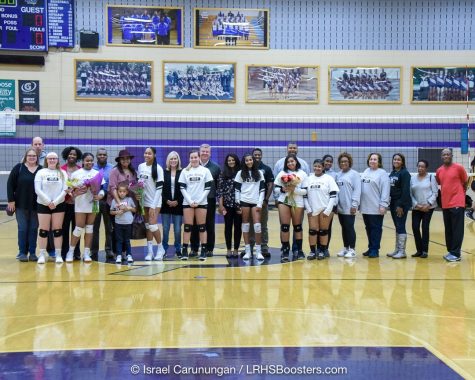 Senior Varsity Volleyball players at their senior game on October 24, 2019 with their families. From left to right: Elizabeth Liedahl, Rayna Livingston, Brianna Chinn, Lindsay Hall, Shyla Harvin, Lauren Lee, and Hadiya Letren. 
Photo Courtesy of Long Reach Boosters. 