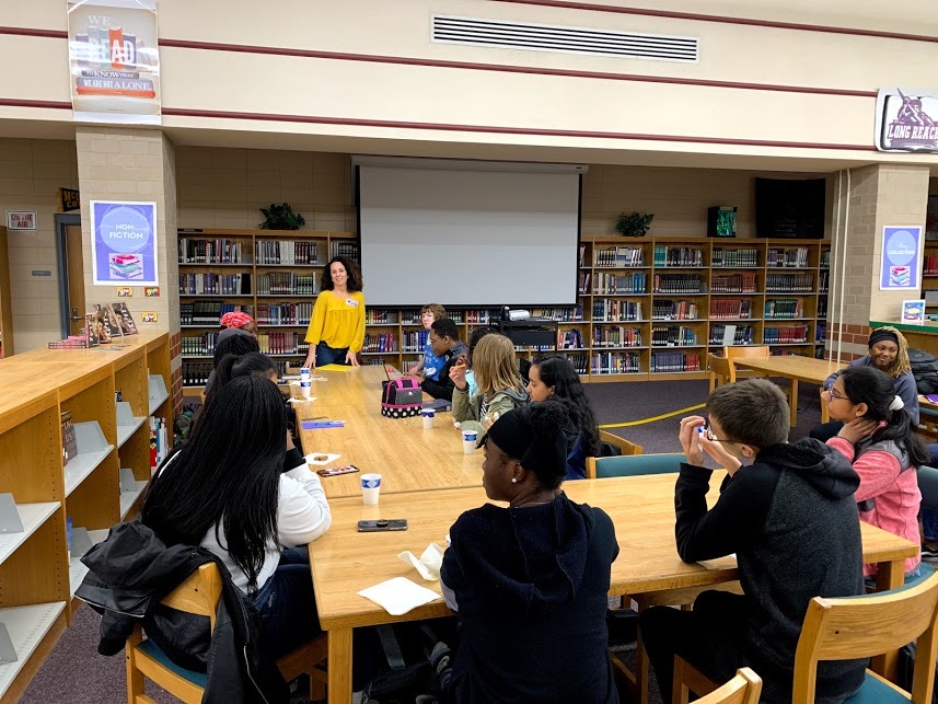 Author Heather Cumiskey with Long Reach High School students in the media center after school. Photo courtesy of Ms. Lee.  
