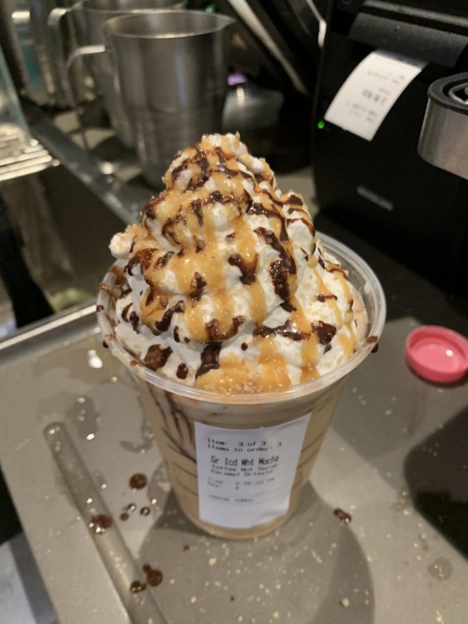 An iced salted caramel white chocolate mocha with caramel and mocha drizzle. Photo taken by author.