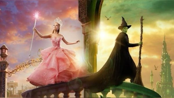 A dramatic split scene shows two witches on opposite sides of an archway: on the left, a glowing figure in a flowing pink gown holds a sparkling wand against a warm sunset sky; on the right, a green-skinned witch in black robes and a pointed hat holds a broom, framed by a darker, green-tinted sky and distant spires.